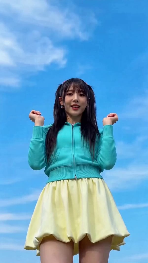 9:16 vertical music video, low-angle medium shot, a lively stylish young woman dancing directly…