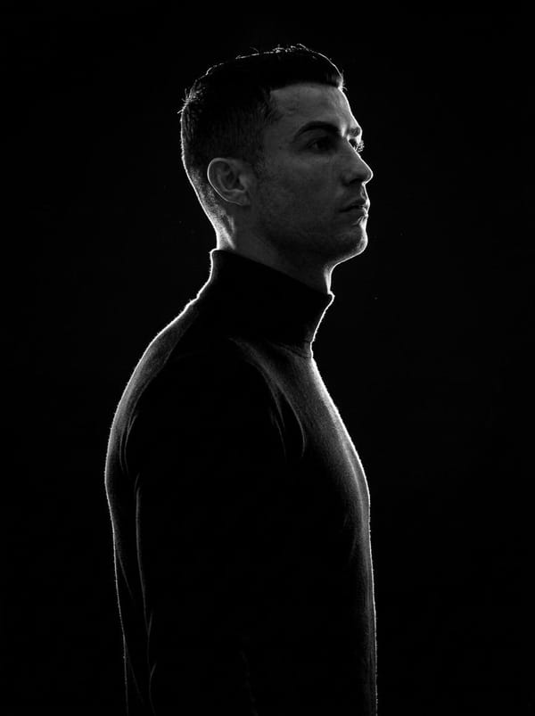 A minimalist black and white cinematic portrait featuring two individuals (male and female) in…
