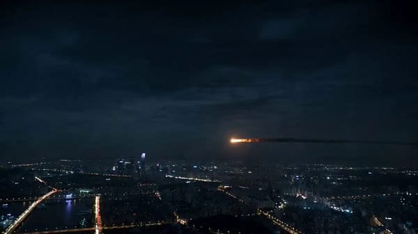 A glowing asteroid enters the atmosphere above a sprawling metropolis at night. prompt example