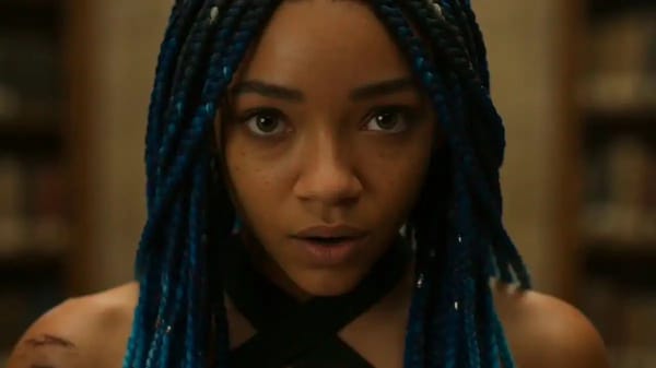 A 19-year-old woman with micro braids dyed deep indigo, warm brown skin, wearing a shredded athleti… prompt example