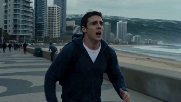 A man sprinting through a coastal city, panic in his eyes, water reflecting in the distance. Tu…