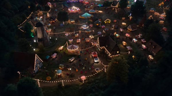 Camera behaves like invisible spirit floating through festival [0–5s]: Floating high above vill…