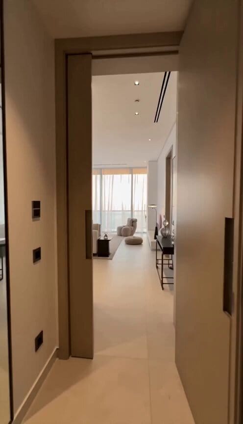 Create a cinematic luxury real estate video of a modern Dubai-style villa with marble floors, d…