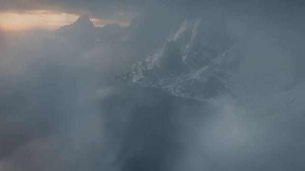 [0–5s]: Vertical descent from sky Ultra-high altitude above a sunny, orc coastal fortress at st…