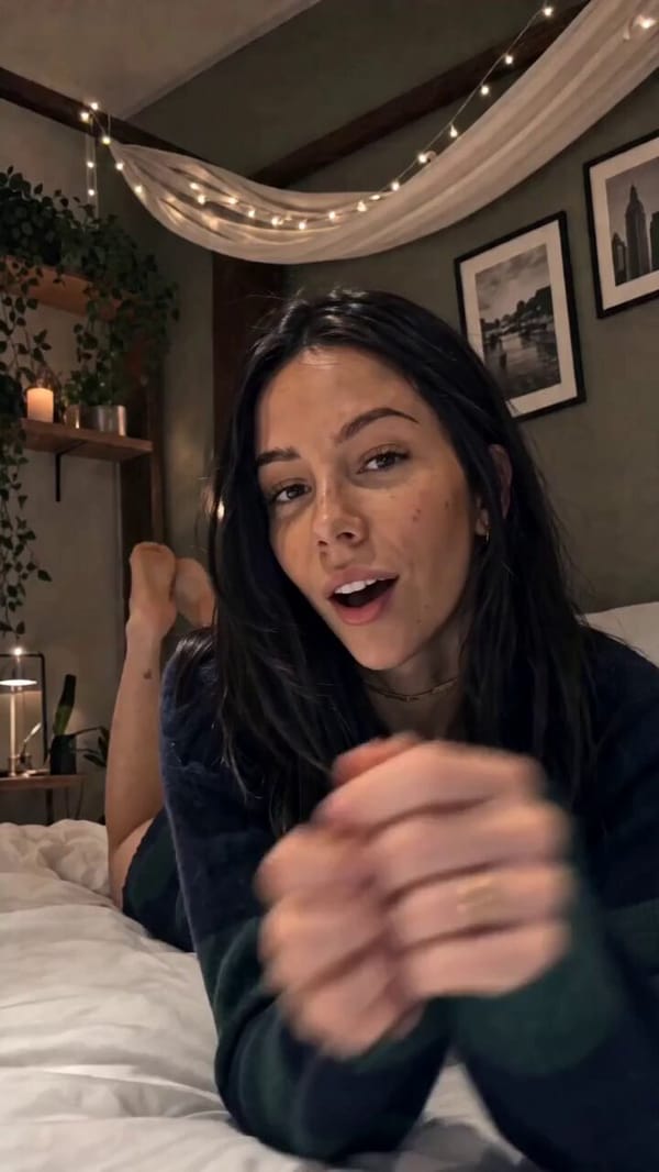 Vertical 9:16 selfie-style video filmed on an iPhone, locked-off and steady, phone propped at t…