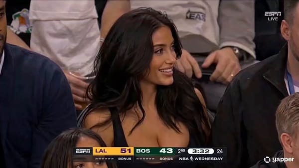 Courtside at a live NBA game, an ESPN broadcast cuts to a young woman in her 20s sitting in the fro… prompt example