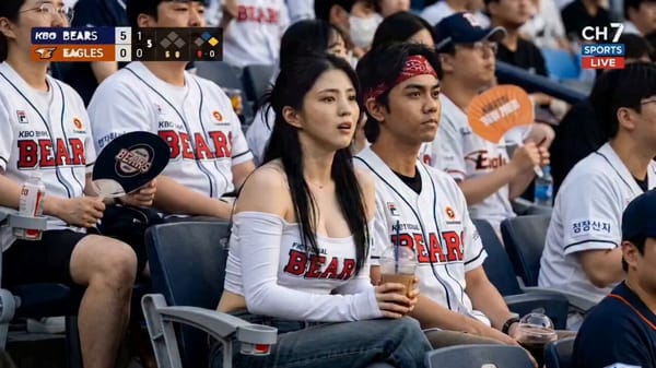 Cinematic, high-fidelity shot of a beautiful young woman with long black hair sitting in a crowded… prompt example