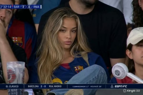Cinematic close-up of a beautiful blonde woman sitting in the football stadium crowd during El…
