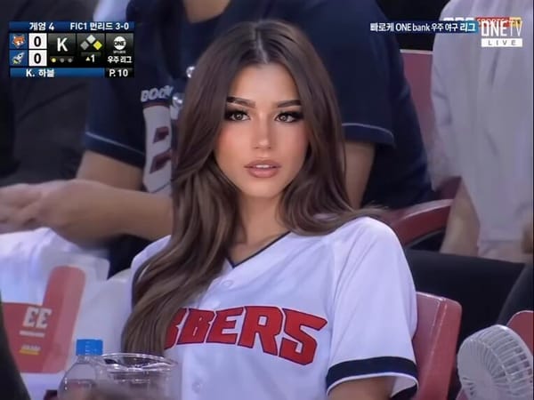 Cinematic, ultra-realistic video of a stunning young woman with long, flowing brown hair sittin…