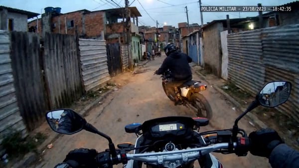 "Motorcycle police helmet POV camera, one continuous high-speed police chase through a dense city.… prompt example