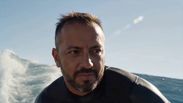 Create a hyper-cinematic 15-second surfing film using @image1 as a strict identity reference. P…
