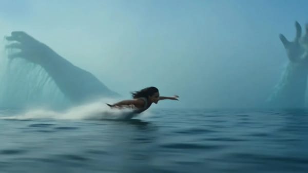 A fearless young woman skims at high speed across a vast misty ocean, hovering inches above the…