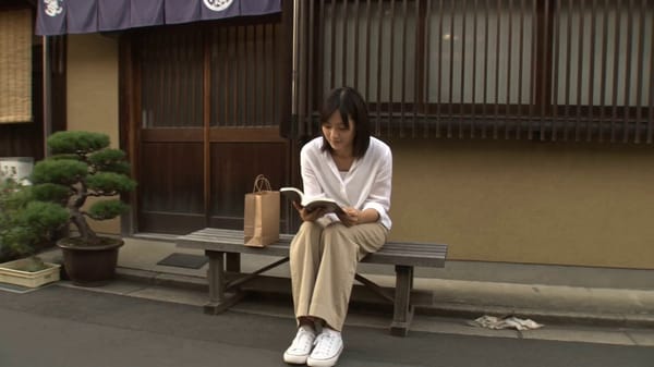 Main subject: Young Japanese woman, mid-20s, natural everyday appearance, soft oversized white…