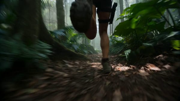 Hyper-realistic cinematic jungle survival sequence, 10-second blockbuster action reel set in a…