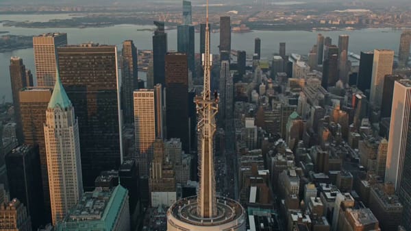 Ultra-photorealistic cinematic drone footage. A lone couple stands on the Empire State Building…