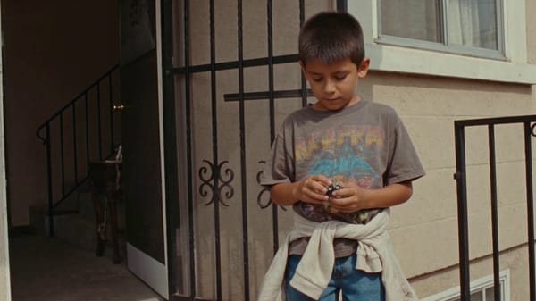 Create a 15-second nostalgic VHS-style video of a little boy from the 1990s, edited from severa…