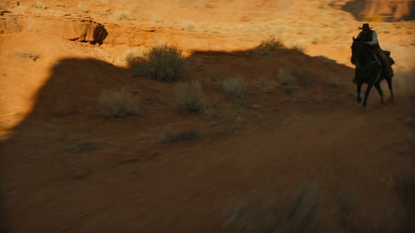 [STYLE + CAMERA + ATMOSPHERE] Live-action FHD moody western horse chase across a dramatic arid…