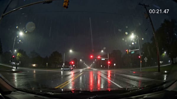 Authentic dashcam footage, fixed wide-angle lens mounted behind a windshield, slight lens disto…