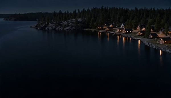 Shot 1 (0–8s) - Wide establishing aerial: A small lakeside town at night, seen from a slow, hig…