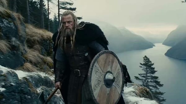 Main Subject Legendary Viking chieftain, mid-30s, towering and broad-shouldered, long windblown…