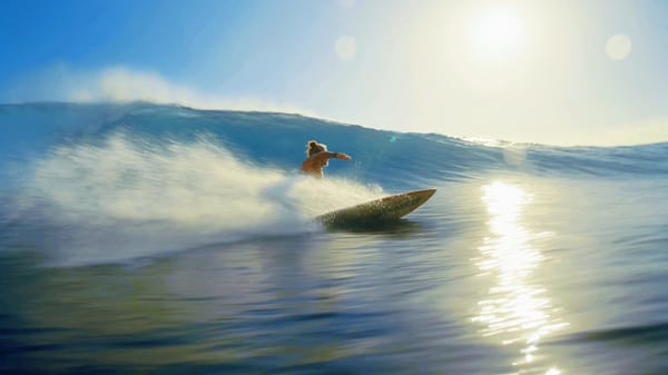A legendary 70-year-old professional surfer with the exact identity of @Image1. Maintain absolu…