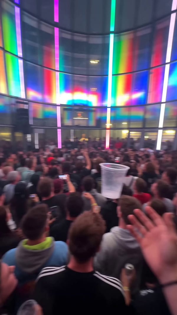 aesthetic: phone camera held by someone inside an indoor skydiving wind tunnel converted into a…