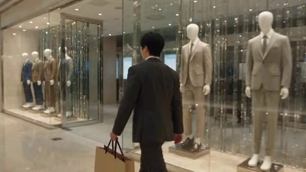 Create a cinematic action sequence of a sharply dressed man walking through a modern shopping m…