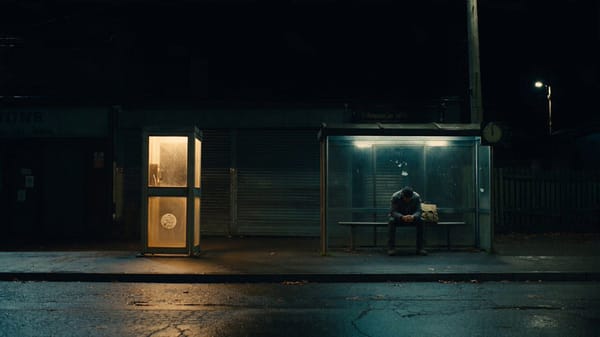 SCENE CONTEXT The opening scene of a suspense short. A man waits alone at a small-town bus stop…