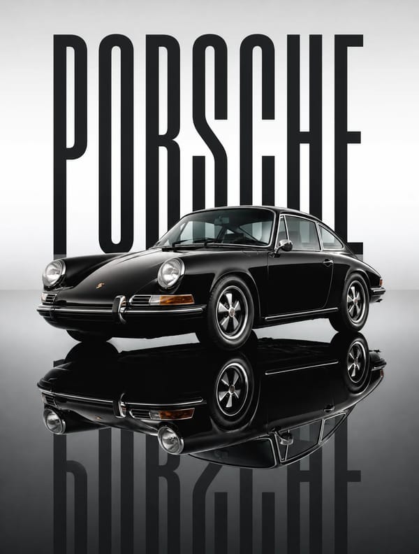 A pristine black 1969 porsche sits stationary on a dark, mirror-like reflective surface, its gl…